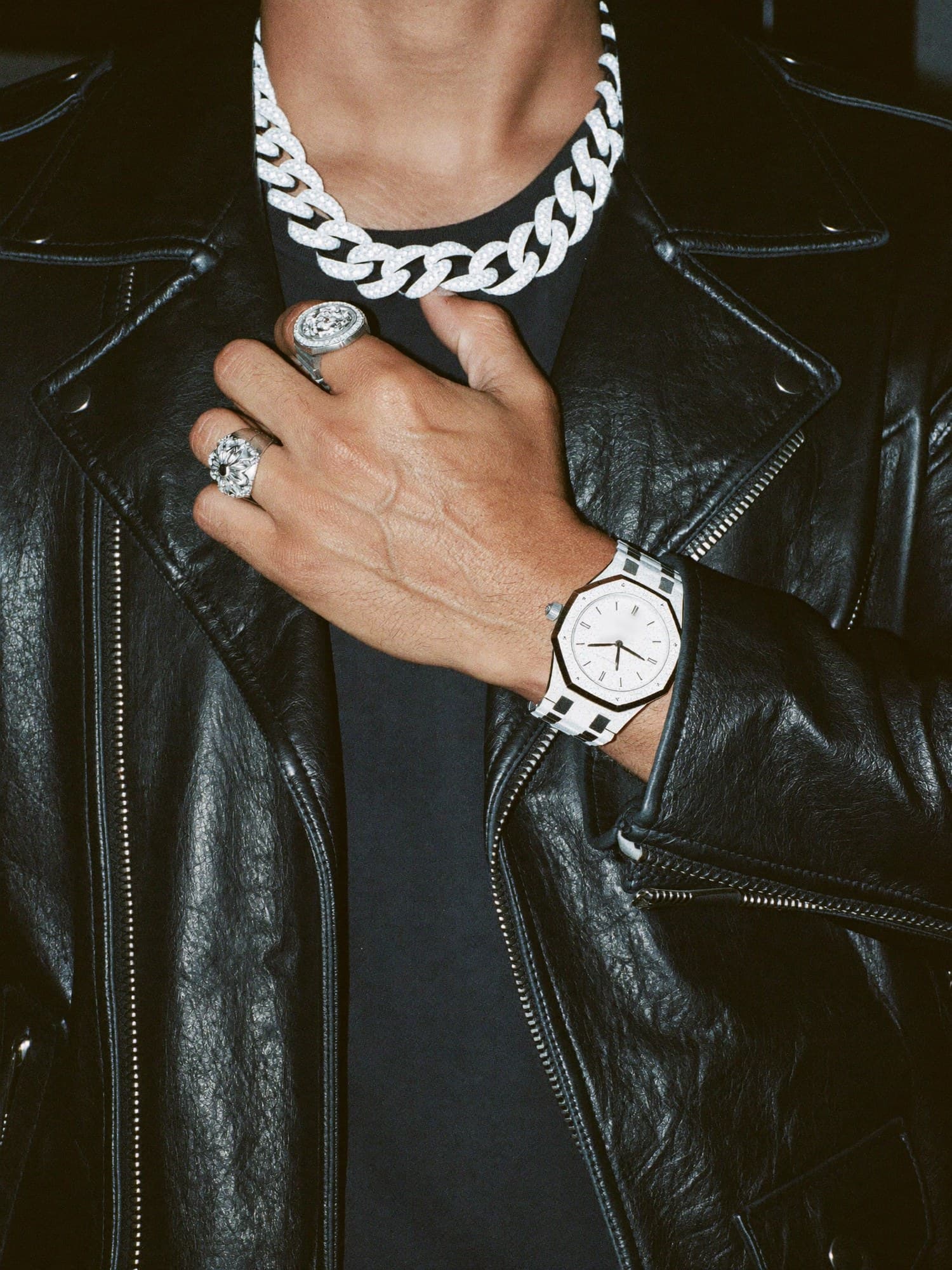 An iced cuban link chain and an iced octagon watch under a hard flash