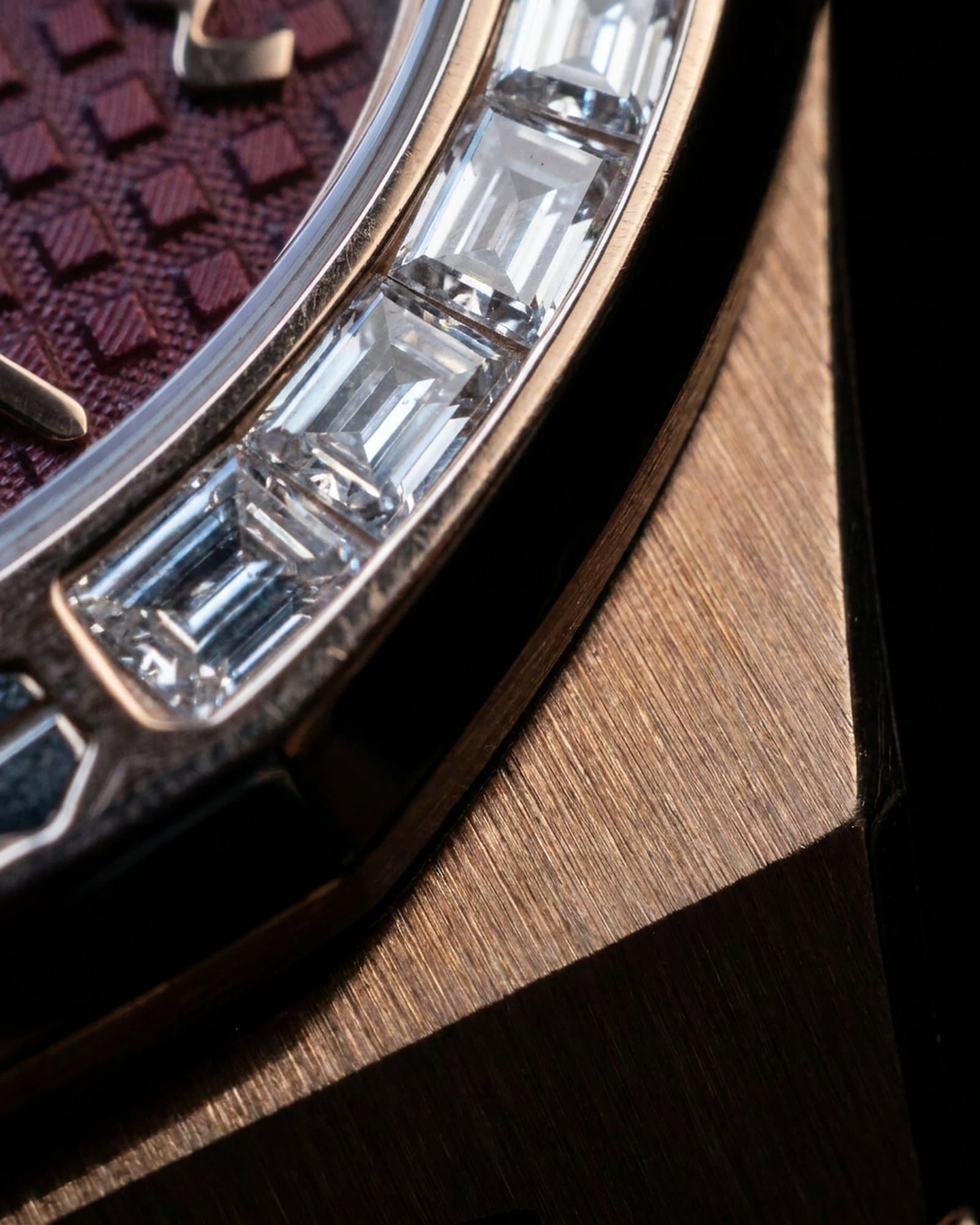 Close-up of the baguette-set bezel and burgundy dial