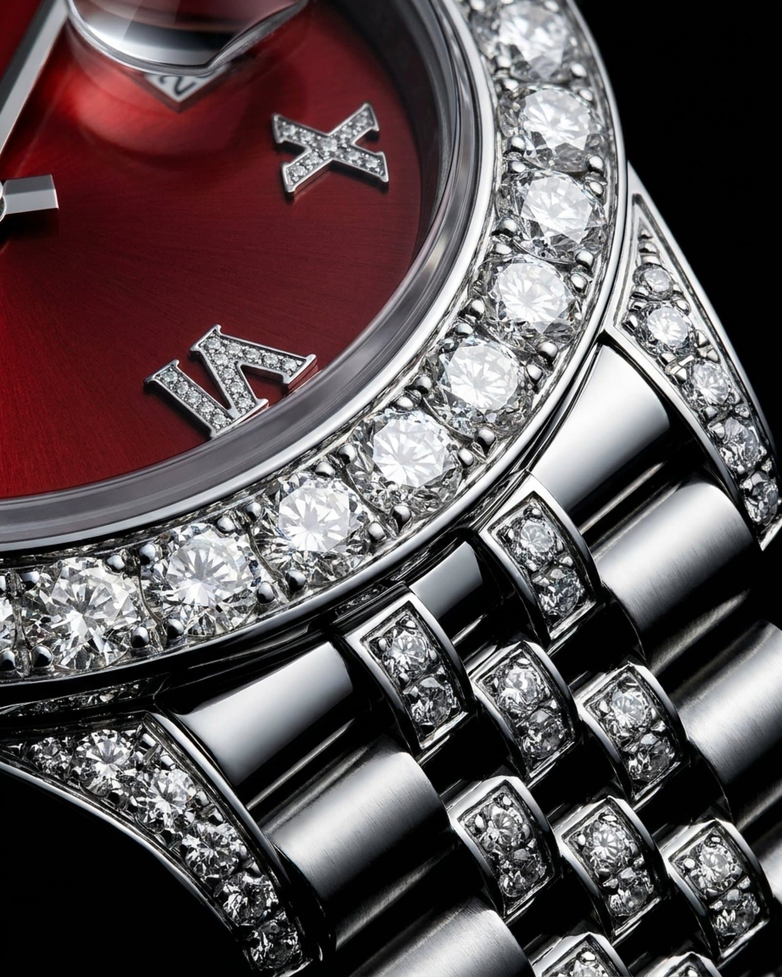 Close-up of the stone-set bezel beside the red dial