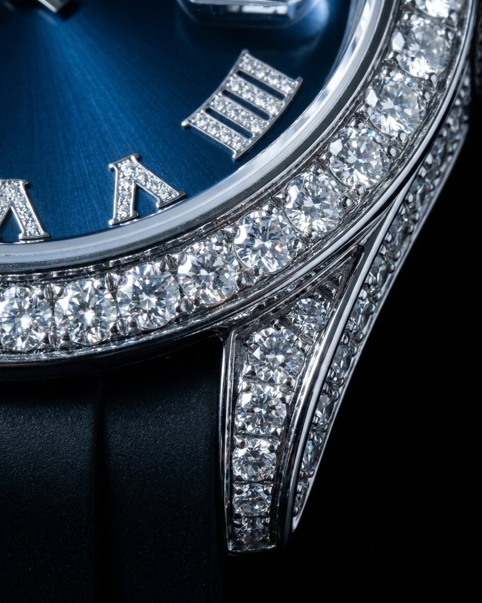 Close-up of the set bezel beside the blue dial and the rubber strap