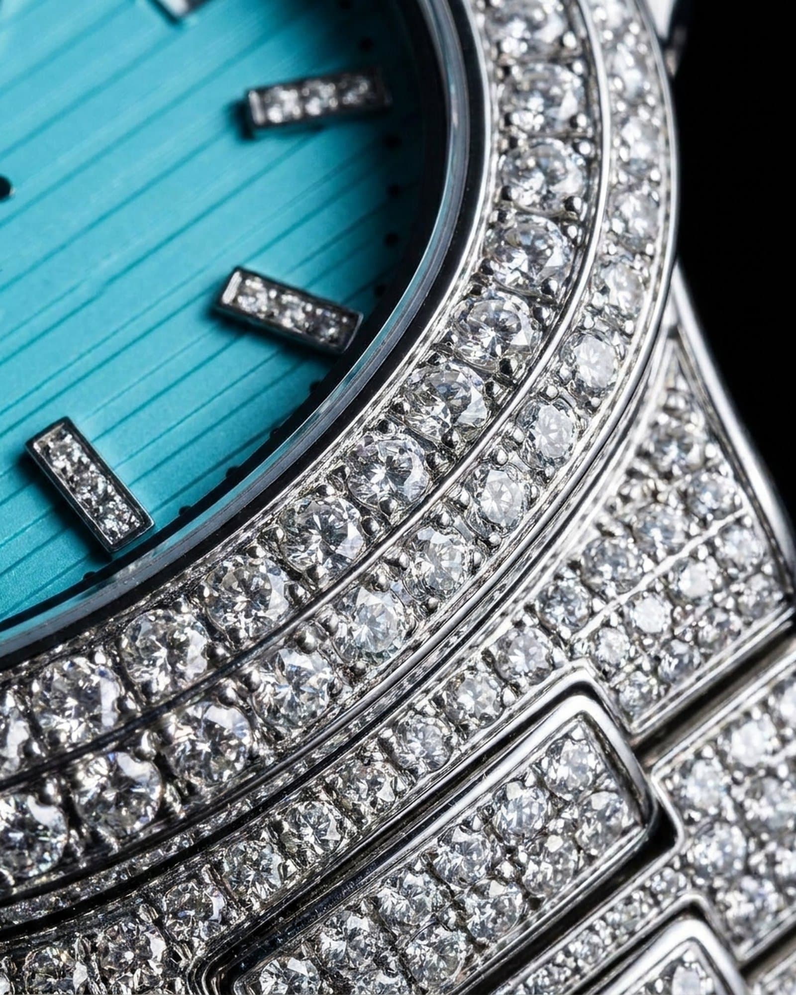 Close-up of the set bezel curving past the sky blue embossed dial