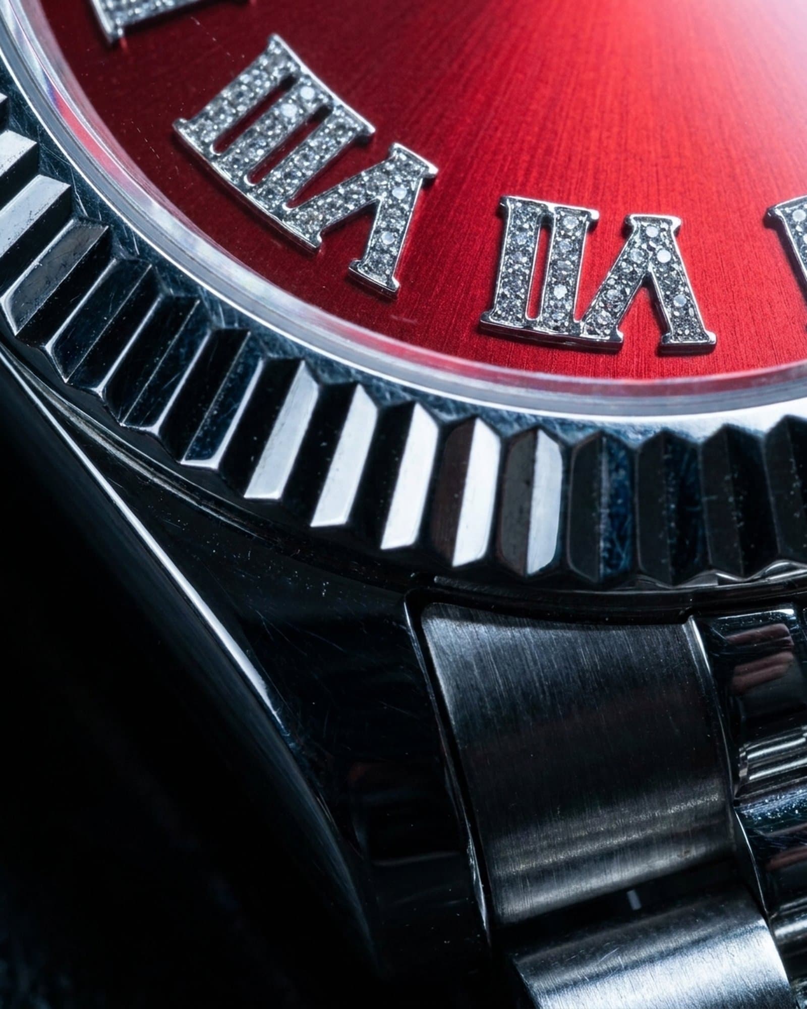 Close-up of the stone-set numerals on the red dial
