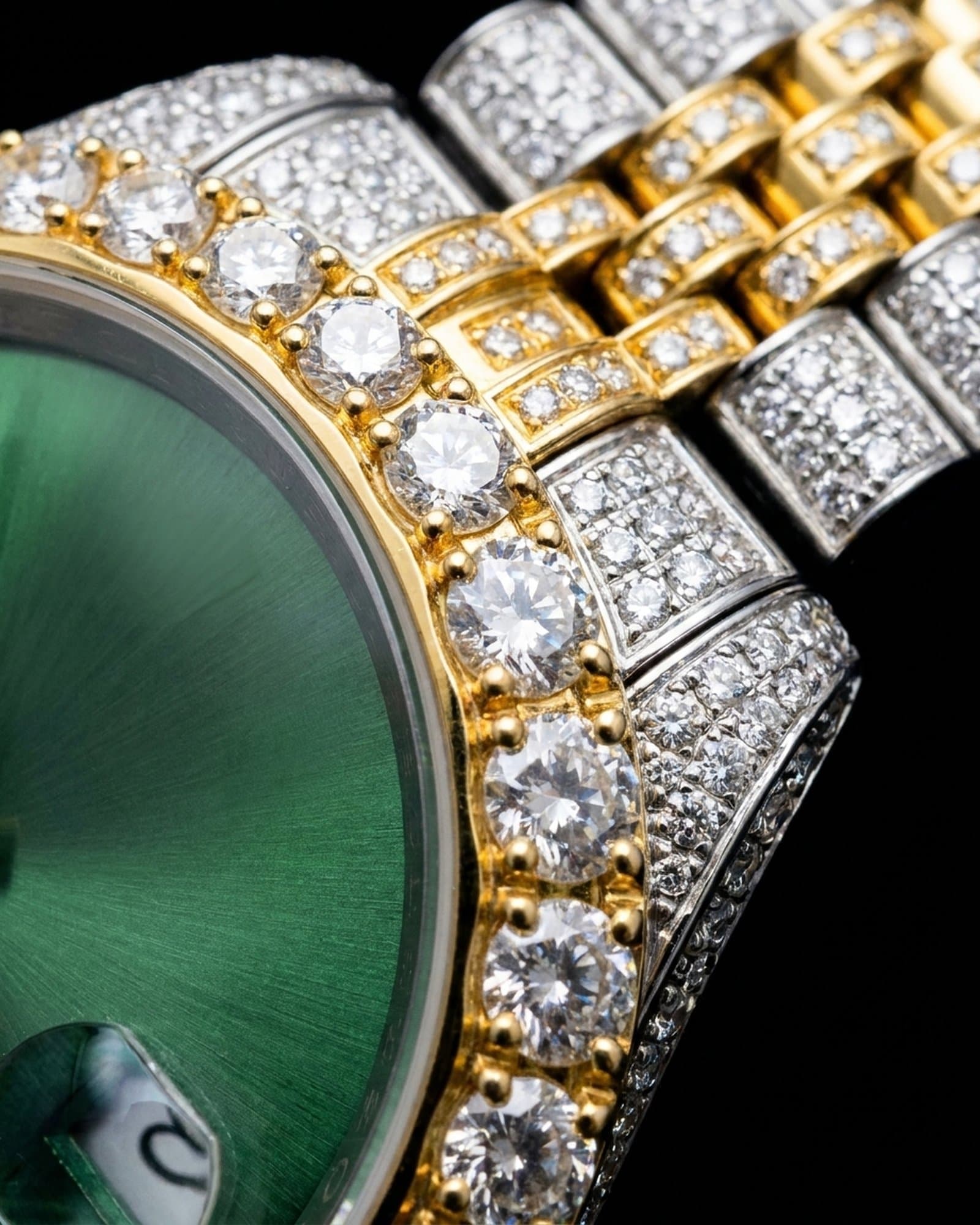 Close-up of the large bezel stones beside the green dial
