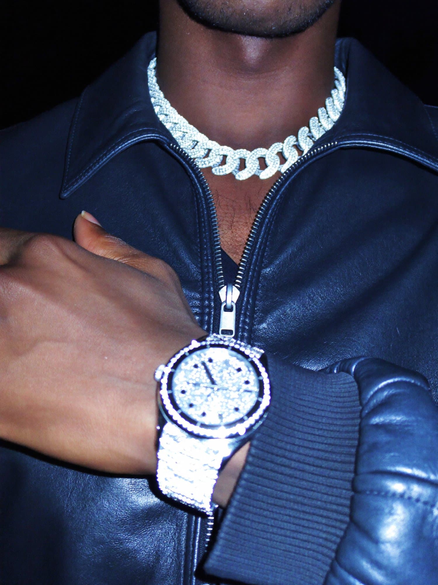 Iced cuban chain and watch under a hard flash at night
