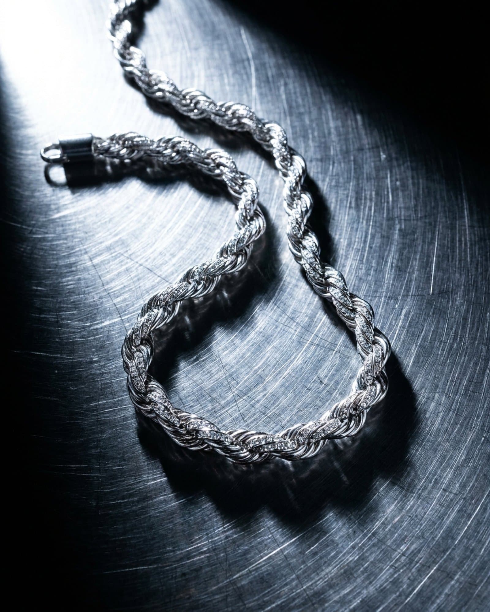 Iced rope chain twisted across scratched steel