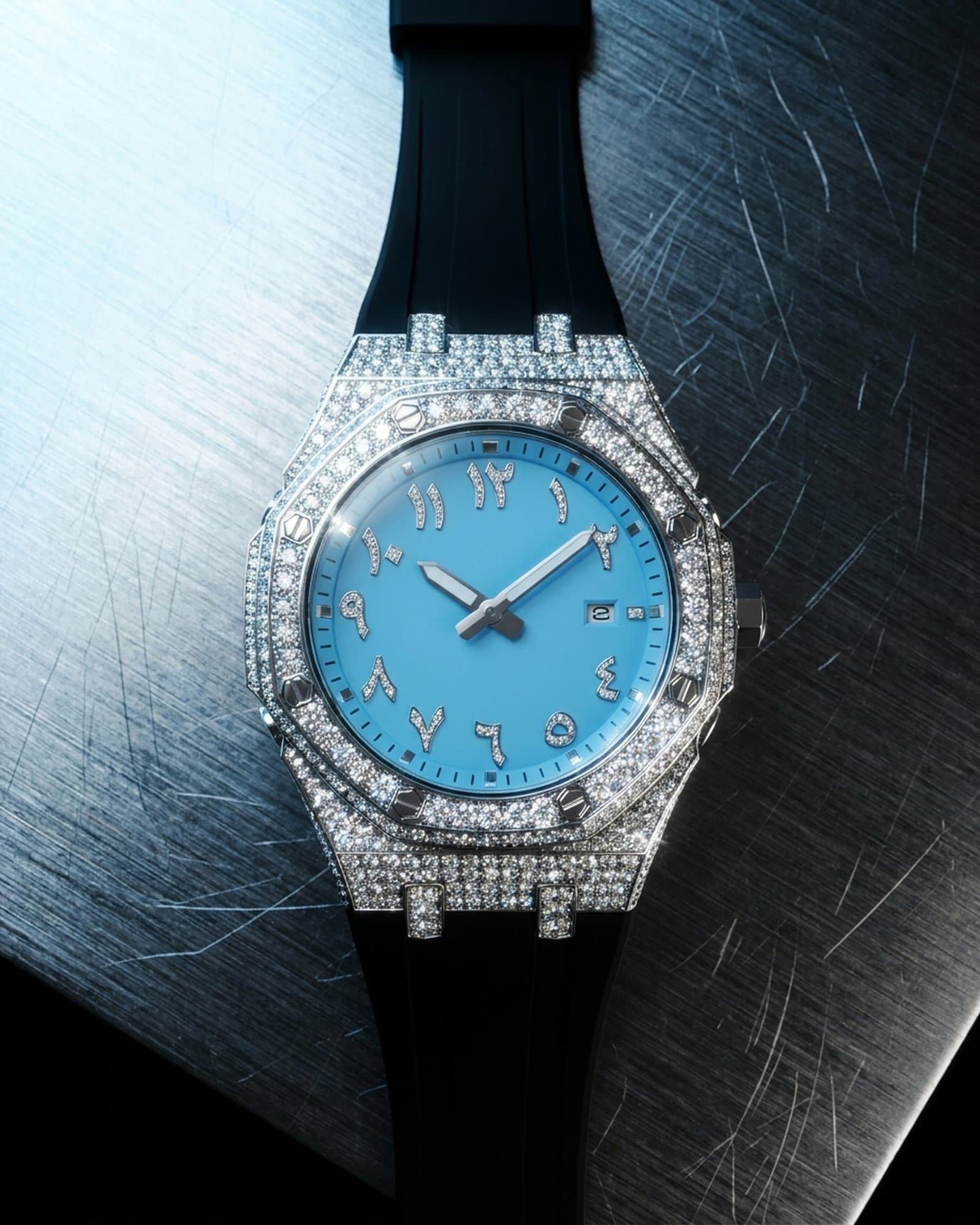 Octagon watch with a blue dial and black rubber strap lying on scratched steel
