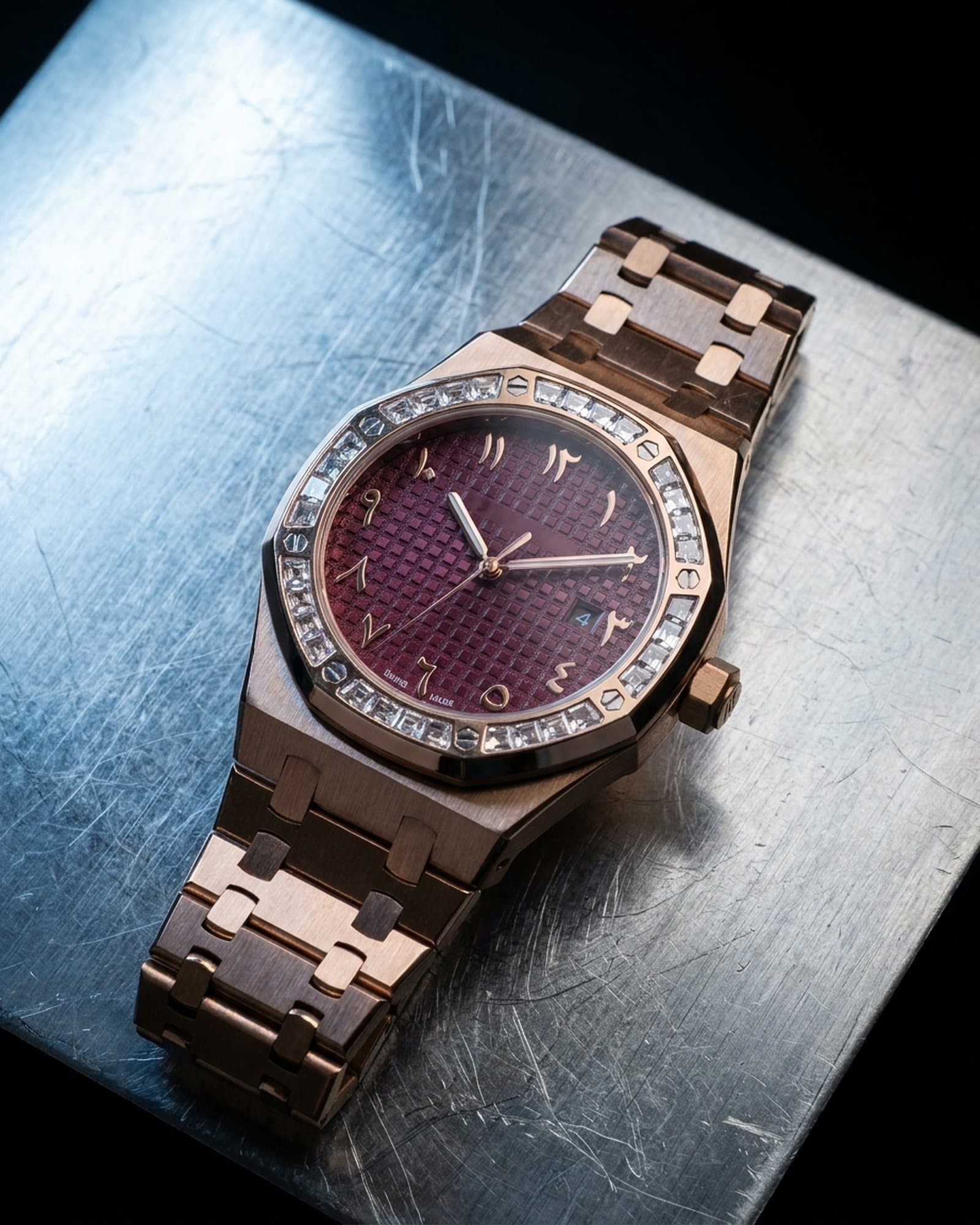 Rose gold octagon watch with a baguette bezel lying on scratched steel